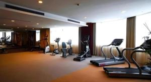 a gym with treadmills and exercise equipment in a building at New Century Hangzhou Qiandao Lake Longting Hotel in Thousand Island Lake +37 photos