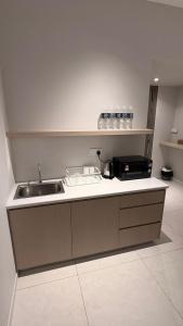 a kitchen with a sink and a counter top at Seaview Cosy BS Homestay in Kota Kinabalu