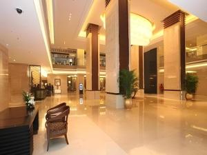a lobby with a chair in the middle of a building at Wuhan Soluxe Hotel in Wuhan