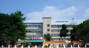a building with a sign on the side of it at Nanning Hawks Holiday Hotel in Nanning