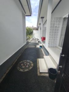 a hallway of a building with a row of benches at Kubusawah Guest House in Seminyak