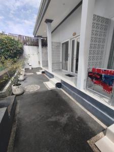 a patio of a house with a red couch at Kubusawah Guest House in Seminyak +7 photos