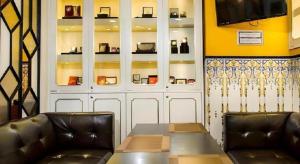 a dining room with two leather chairs and a table at Happy Family Hotel in Macau
