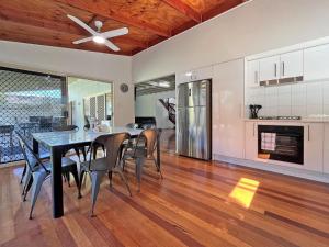 a dining room and kitchen with a table and chairs at Flinders Breeze in Amity Point