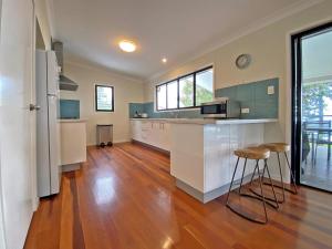 a large kitchen with a counter and a counter top at Annies House in Amity Point