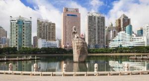 a statue in the middle of a river in a city at Xiamen Jinjiu Hotel in Xiamen +29 photos