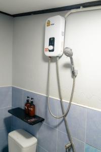 a shower in a bathroom with a blow dryer at บุหลัน ธารา ล่องแก่งสตูล Bulhun Tara Satun in Ban Muang Takua