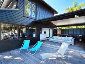 a patio with chairs and a couch on a house at Dolphins at Sunset in Amity Point