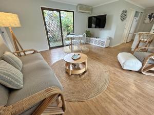 a living room with a couch and a table at Happy Daze in Amity Point