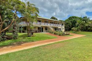 a large house with a porch and a yard at Alla Mare in Amity Point