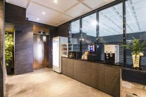 a kitchen with a counter and some windows at Chocolate Hotel Seongnam in Seongnam