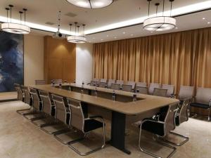 a large conference room with a large table and chairs at Echarm Hotel Changsha High-speed Railway Station in Changsha