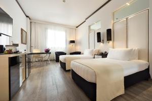 Кровать или кровати в номере Meliá Milano