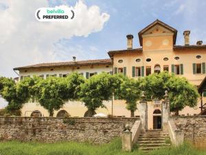 an image of a large house with a stone wall at Villa in Valbelluna with Pool & Dolomite Views in Santa Giustina