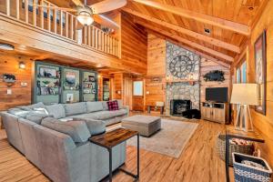 a living room with a couch and a fireplace at Cozy Walnut Mountain Cabin with Hot Tub & Views in Ellijay