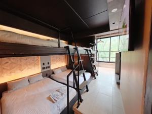 a group of bunk beds in a room at trive sakae 最大7名宿泊可能 矢場町駅徒歩3分 栄 大須観音スグ in Nagoya
