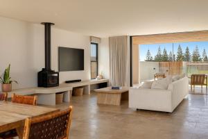 a living room with a white couch and a tv at Wave Break in North Creek