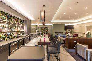 a restaurant with tables and chairs and a bar at Hotel & Restaurant Schönau in Peine