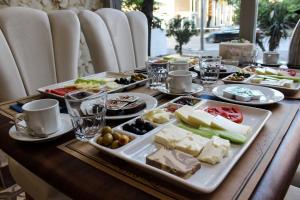 a wooden table with plates of food on it at Grand Bursa Hotel in Bursa