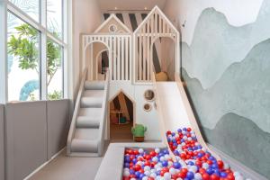 a play room with a slide and balls at Novotel Dubai World Trade Centre in Dubai