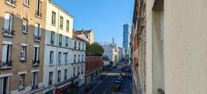 Una vista de una calle de la ciudad desde un edificio. en Appartement paisible, en Clichy