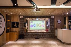 a projection screen on a brick wall in a room at HOTEL HI- Chui-Yang in Chiayi City