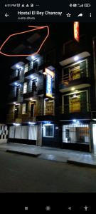 a night view of a building with lights on at Hotel EL REY in Chancay