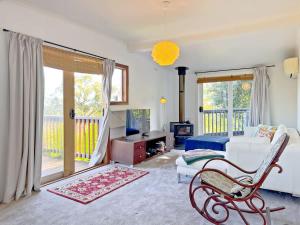 a living room with a couch and a chair at La Cachette in Upwey 3BR Retreat with Mountain Views in Upwey
