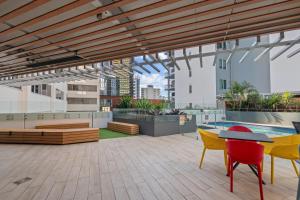 a patio with a table and chairs on a building at Evolve Apartments Brisbane in Brisbane