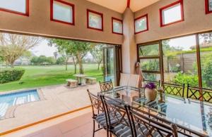 a dining room with a view of a pool at Pecanwood Haven Hartbeesport Dam in Hartbeespoort