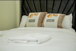 a close up of a bed with two pillows at Tiny Haven studio with free WIFI and Netflix in Nanyuki