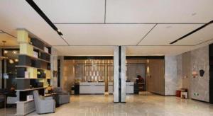 a large room with a lobby with couches and tables at Echarm Hotel Chengdu Happy Valley Southwest Jiaotong University in Chengdu