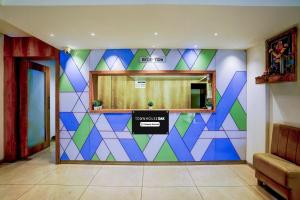 a room with a colorful wall with a mirror at Super Townhouse Oak New Nashik Highway Kalyan Bhiwandi in Kalyan
