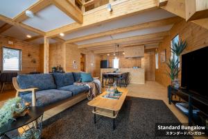 a living room with a couch and a table at Rusutsu Hills CENTRO in Rusutsu