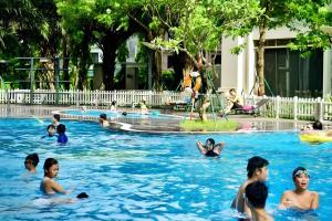 a group of people playing in a swimming pool at Alice's home Times city in Hanoi