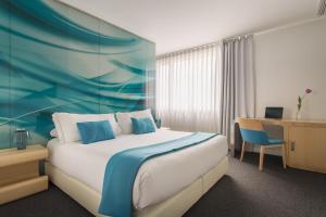 Pokój hotelowy z łóżkiem i biurkiem w obiekcie Room Mate Oscar w Madrycie