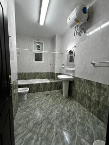 a bathroom with a sink and a toilet and a sink at Bliss Spot Vacation Homes in Al Ain +76 photos