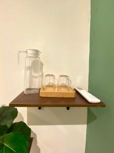 a wooden shelf with two glasses and a blender on it at Sembilan Inn by Soft Loft in George Town