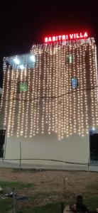 a white building with lights on it at night at Sabitri Villa in Konārka