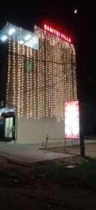 a building with lights on the side of it at night at Sabitri Villa in Konārka +1 photo