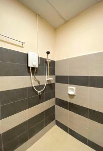 a bathroom with a shower with black and gray stripes at Sembilan Inn by Soft Loft in George Town +47 photos