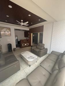 a living room with a couch and a table at Reva suites in Arsikere