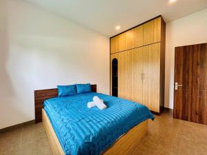 a bedroom with a bed with two towels on it at Kim Apartment - Cozy 1BR for Couples in Thảo Điền - Yellow in Ho Chi Minh City