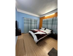 a bedroom with a bed and a television in it at HotelSonamTawang in Tawang
