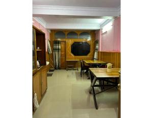 a hallway with a table and chairs and a television at HotelSonamTawang in Tawang