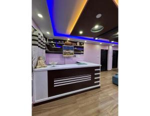 a kitchen with purple walls and a counter top at HotelSonamTawang in Tawang