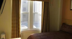a bedroom with a window and a bed in a room at Post Hotel in San Francisco +135 photos