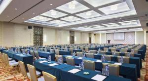 a large banquet hall with blue tables and chairs at Datong Hotel in Datong
