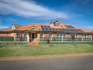 a house with solar panels on the roof at Ascot on Swan Bed & Breakfast in Perth