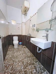 a bathroom with a sink and a toilet at Mai Chau Hostel in Mai Chau